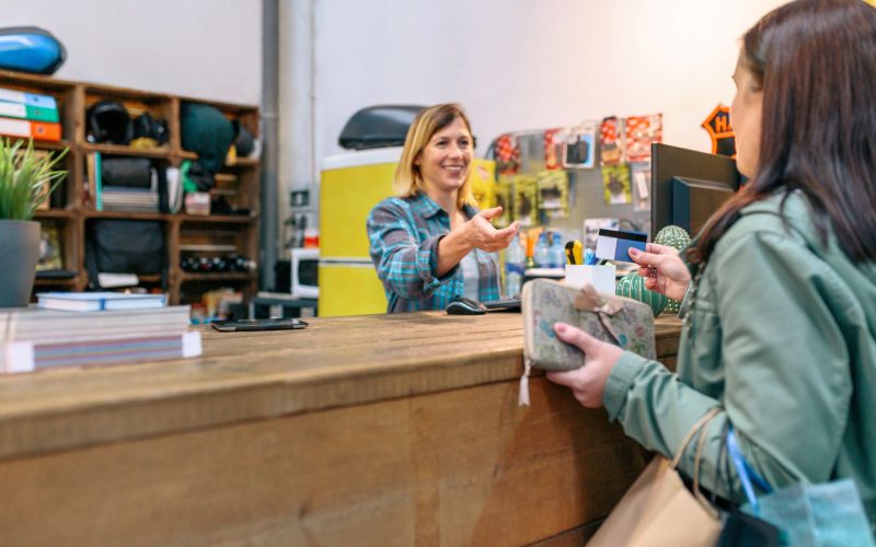 A customer giving credit card to a shop assistant